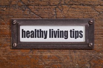 healthy living tips - file cabinet label, bronze holder against grunge and scratched wood